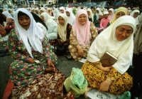 Malaysia, Kota Bharu, overflow crowd of women listen to a sermon on a dusty street outside a local mosque. - Steve Raymer