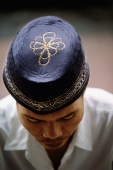 Indonesia, Jakarta, Worshipper wears an embroidered prayer cap, called a songkok or kopiah, at Istiqlal Mosque. - Steve Raymer