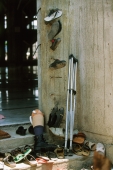 Thailand, Yala, Artificial limb among shoes and sandals outside mosque. - Steve Raymer