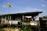 Brunei, Kampong Ayer, A typical home flies the Brunei flag. - Steve Raymer
