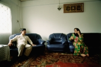 Malaysia, Abdullah Juhaidi and his wife Zainab stealing a few moments during the Hari Raya Adilfitri holidays. Juhaidi is a convert to Islam. - Steve Raymer