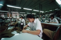 Vietnam, Ho Chi Minh City, Women sewing fabric in a factory. - Steve Raymer