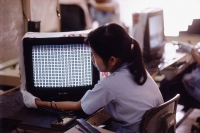 Vietnam, Ho Chi Minh City, Women working in a factory checking television sets. - Steve Raymer
