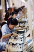 Vietnam, Ho Chi Minh City, Women working to assemble circuit boards in a factory. - Steve Raymer