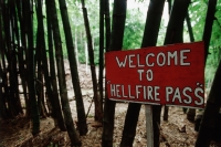 Thailand, Kanchanaburi, Hellfire Pass, A hand-painted sign welcomes visitors to the beginning of the Hellfire Pass trail. - Steve Raymer