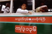 Myanmar (Burma), Yangon (Rangoon), Passengers looking out the windows of a bus. - Steve Raymer