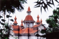 Myanmar (Burma), Yangon (Rangoon), Spires of a colonial building peeking over foliage. - Steve Raymer