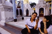 Myanmar (Burma), Yangon (Rangoon), A man making a call on his cell phone at the Shwedagon Pagoda. A privileged few are allowed to own and operate mobile phones in Myanmar. - Steve Raymer