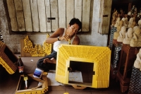 Myanmar (Burma), Yangon (Rangoon), A Craftsman putting finishing touches on a souvenir for sale at one of hundreds of shops outside of the Shwedagon Pagoda. - Steve Raymer