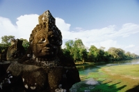 Cambodia, Siem Reap, A statue in Angkor - John McDermott