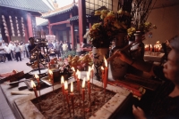 Malaysia, Kuala Lumpur, Chinatown, Man praying at Chinese Temple. - Steve Raymer