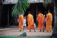 Vietnam, Mekong Delta region, Bac Lieu, Buddhist monks walking on street in search of alms. - Steve Raymer