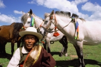 China, Szechuan (Sichuan), Kham region, Horseman with decorated horses. - Jill Gocher