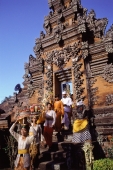 Indonesia, Bali, Hindu festival, People with offerings enter temple via candi bentar (split gates). - Jill Gocher