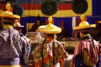 Nepal, Mustang, Buddhist lamas wearing traditional yellow hats during Teeji Festival. - Jill Gocher