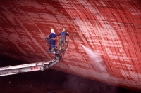 Workers cleaning side of ship at shipyard - Alex Microstock02