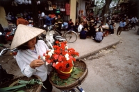 Vietnam, Hanoi, woman holding flowers - Alex Mares-Manton