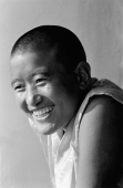 India, near Dharamsala, Dolma Ling Nunnery, Portrait of Tibetan nun smiling. - Mary Grace Long