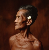 Indonesia, Bali, Ubud, Mature Balinese man with Frangipani flower adornment. - Martin Westlake