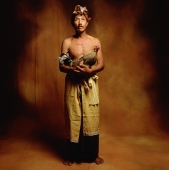 Indonesia, Bali, Ubud, Balinese man holding fighting cock. - Martin Westlake