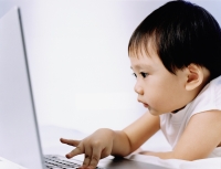 Boy, 3 years old, using laptop. - Erik Soh