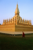 Laos, Vientiane, Buddhist monk walks past Pha That Luang Temple. (grainy) - Martin Westlake