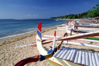 Indonesia, Bali, Sanur Beach, Fishing boats (Jukung) lined up on beach. (grainy) - Martin Westlake