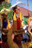 Indonesia, Bali, Tanjung Benoa, Women carrying effigies at Melasti ceremony. (grainy) - Martin Westlake