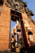 Indonesia, Bali, Gianyar, Cremation ceremony, women carrying offerings leaving temple. (grainy) - Martin Westlake