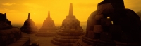 Indonesia, Java, Magelang, Sunrise across stupas on top level of Candi Borobudur. (grainy) - Martin Westlake