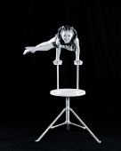 China, Hong Kong, Youngest acrobat of the Shenyang Acrobatic Troupe balancing on both hands - Carsten Schael