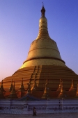 Myanmar (Burma), Bago, Women walking beneath the golden stupa at Shwemawdaw Paya. - Martin Westlake