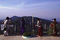 Myanmar (Burma), Kyaiktiyo, Teenage girls use telescopes at view point - 'golden rock'. - Martin Westlake
