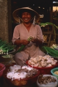 Vietnam, Ben Thanh market, Ho Chi Minh city, Woman selling fruit and vegetables at market stall. - Martin Westlake