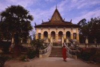 Vietnam, Mekong delta, Trang Vinh Pagoda, Buddhist monk walks through courtyard. - Martin Westlake