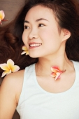 Young woman lying down, flowers in hair - Erik Soh