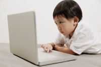 Young boy using laptop - Erik Soh