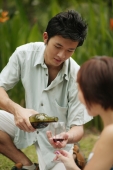 Young man pouring a glass of wine for young woman - Alex Microstock02