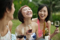 Young women laughing, wine glasses in hand - Alex Microstock02