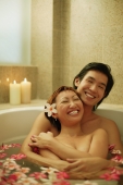 Couple hugging in tub, smiling. - Alex Microstock02