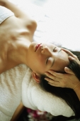 Young woman lying down on massage table - Alex Microstock02