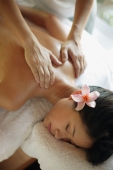 Young woman receiving back massage, eyes closed - Alex Microstock02