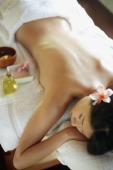 Young woman lying on massage table, eyes closed - Alex Microstock02