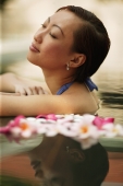 Young woman, at edge of swimming pool, eyes closed - Alex Microstock02