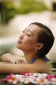 Young woman, at edge of swimming pool, head tilted up. - Alex Microstock02