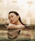 Young woman, at edge of swimming pool, eyes closed - Alex Microstock02