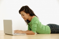 Young woman using laptop - Erik Soh
