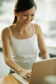 Young woman using laptop. smiling - Alex Microstock02