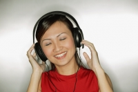 Young woman listening to headphones,  smiling - Alex Microstock02