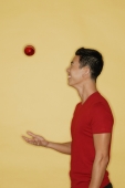 Young man juggling a ball, side view - Alex Microstock02